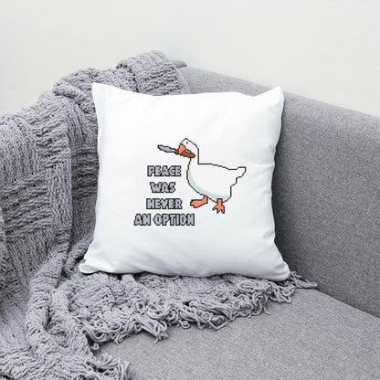 White pillow with a duck graphic and text on a gray couch
