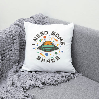 White pillow with 'I Need Some Space' design on a gray couch