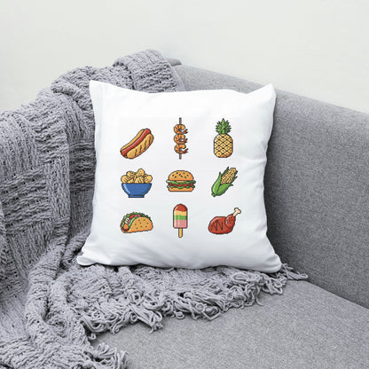 White pillow with food illustrations on a gray couch