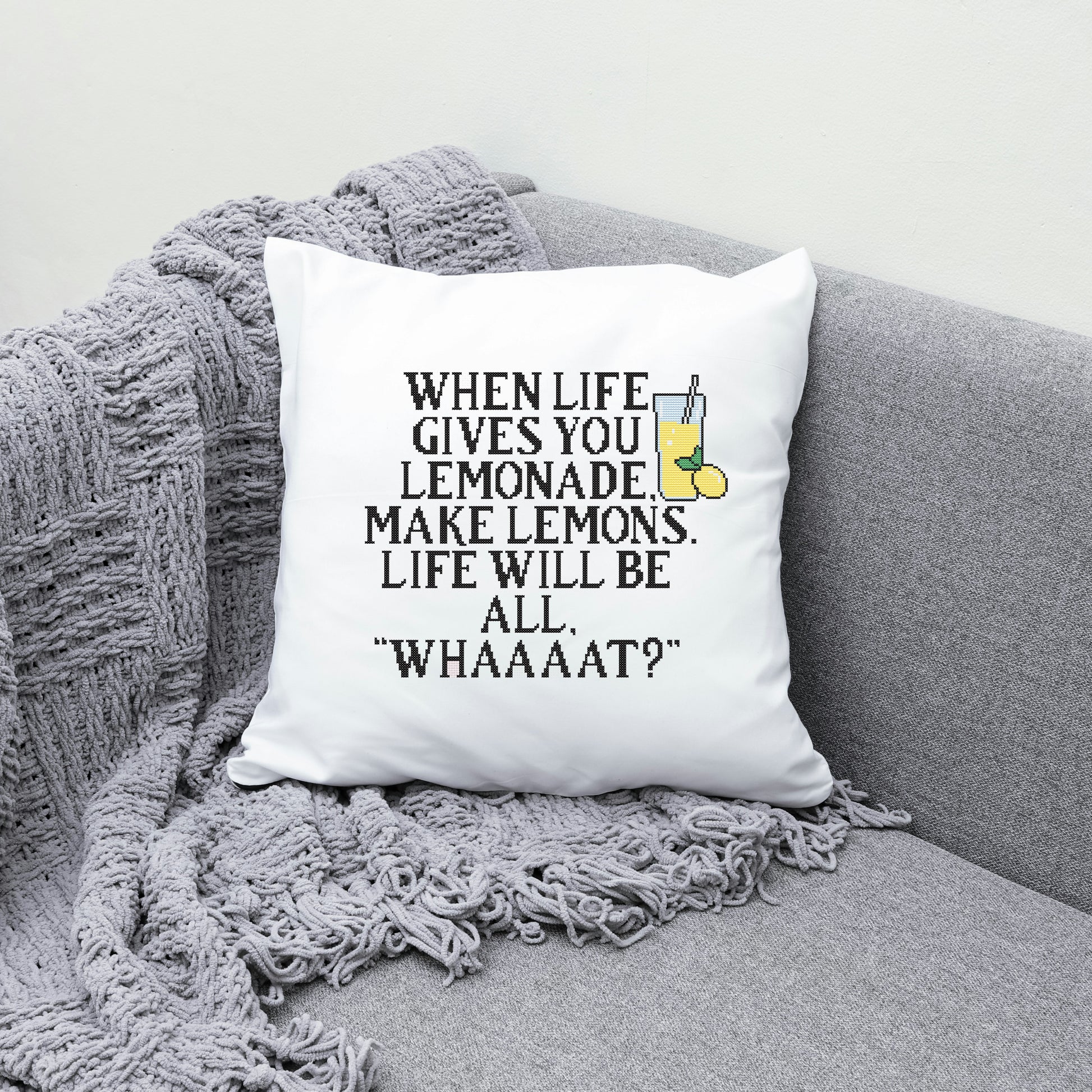 White pillow with humorous quote on a gray couch