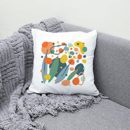 Decorative pillow with colorful abstract design on a gray couch