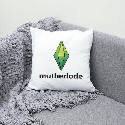 White pillow with 'motherlode' and logo on the grey couch