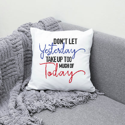 White pillow with motivational quote on a gray couch