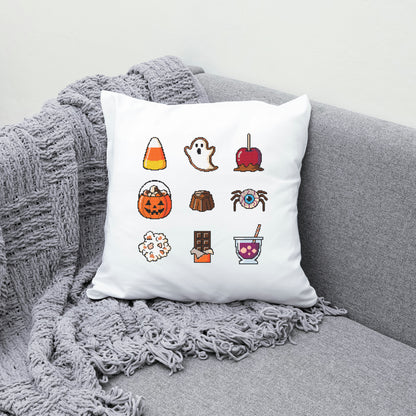 White pillow with Halloween-themed icons on a gray couch