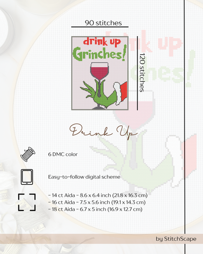 Embroidery design with 'drink up Grinches!' text and hand holding a wine glass on a white background.