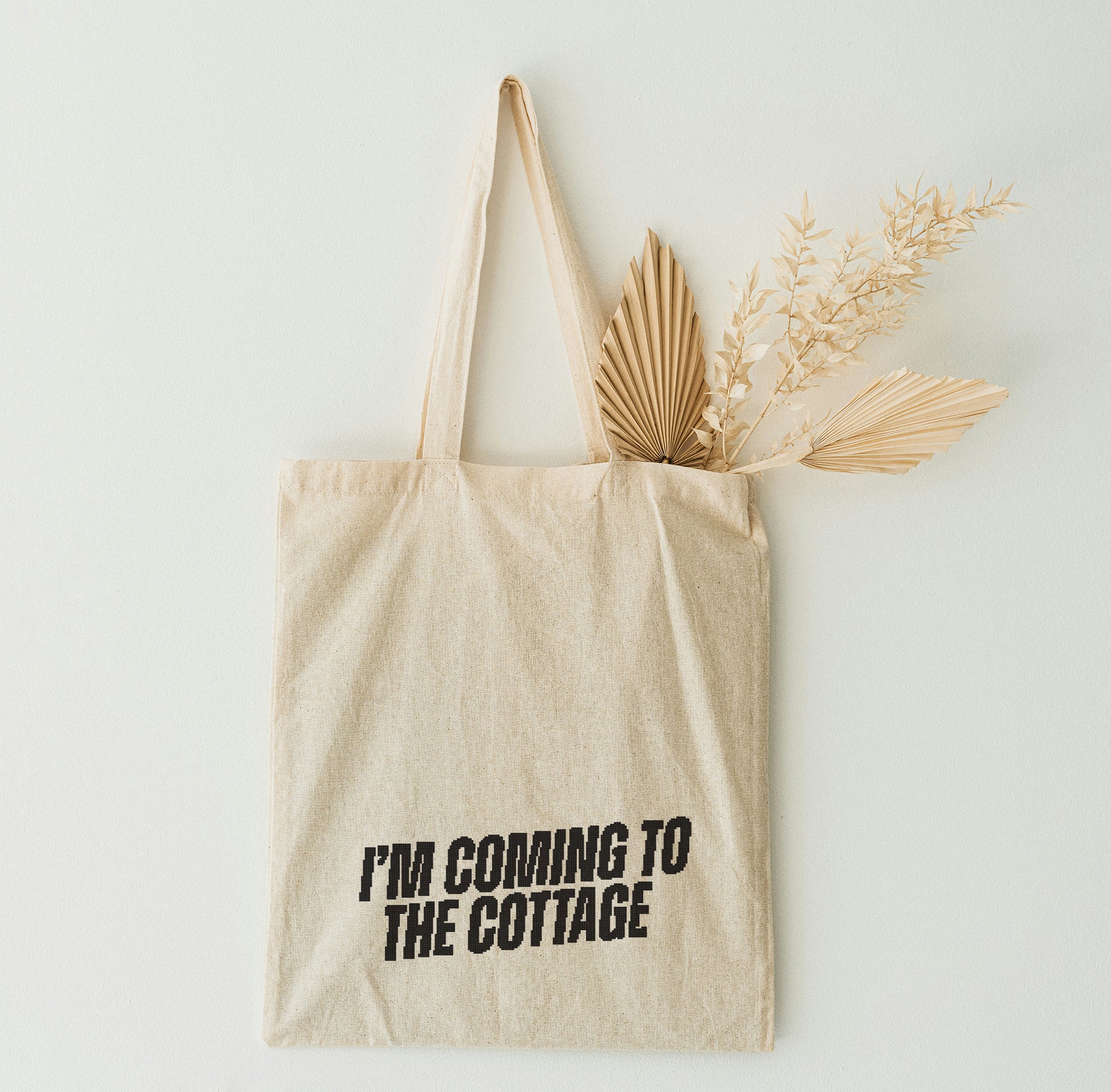 Beige tote bag on the white wall
