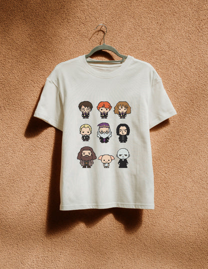 White t-shirt with character illustrations on a hanger against a brown textured wall
