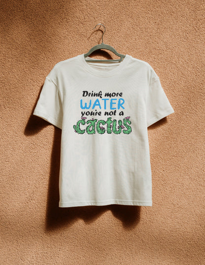 White t-shirt with humorous text on a hanger against a textured brown wall