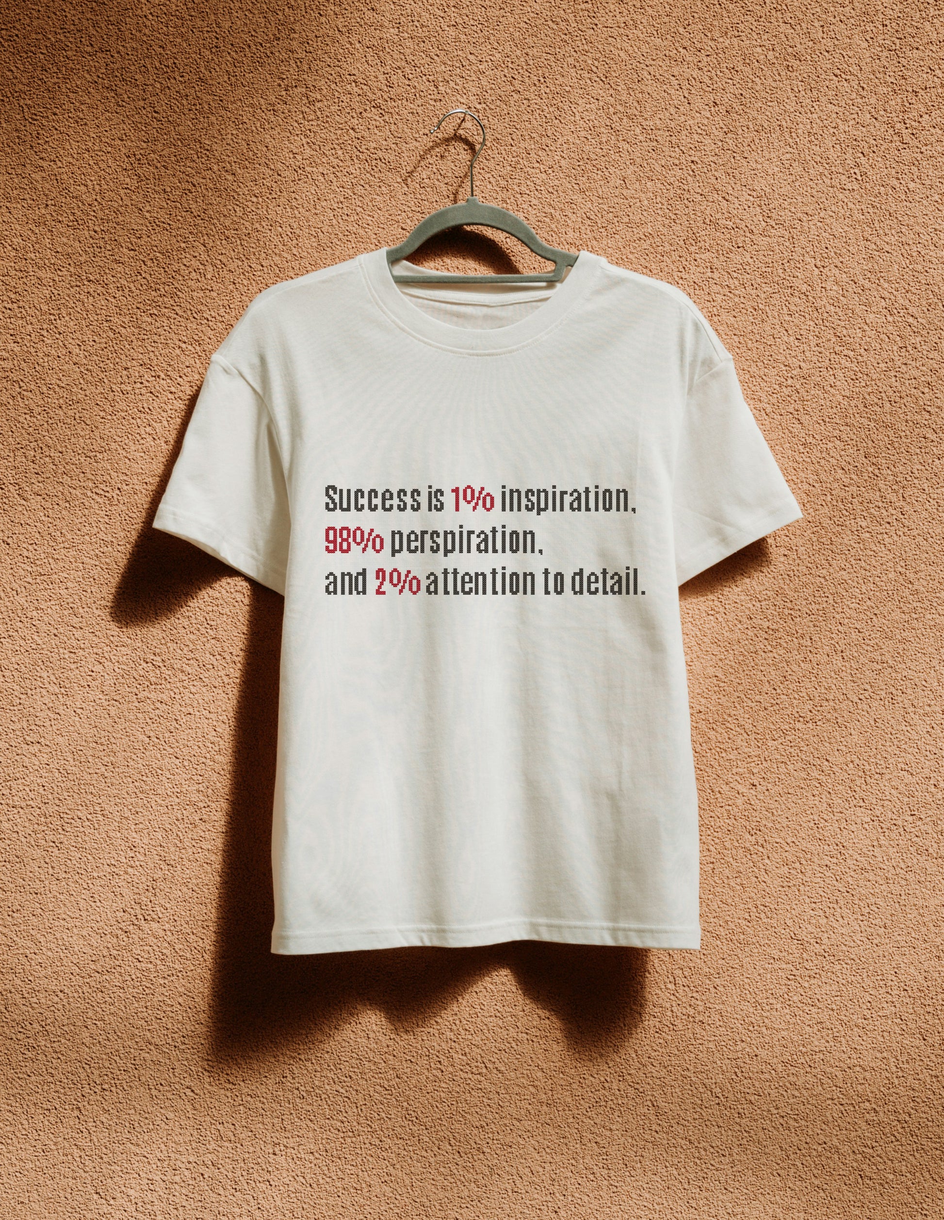 White t-shirt with motivational quote on a beige wall