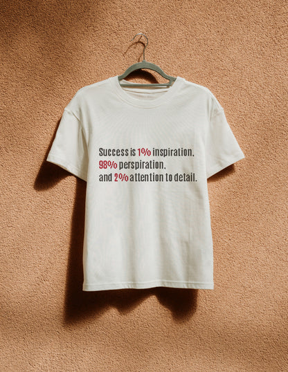 White t-shirt with motivational quote on a beige wall