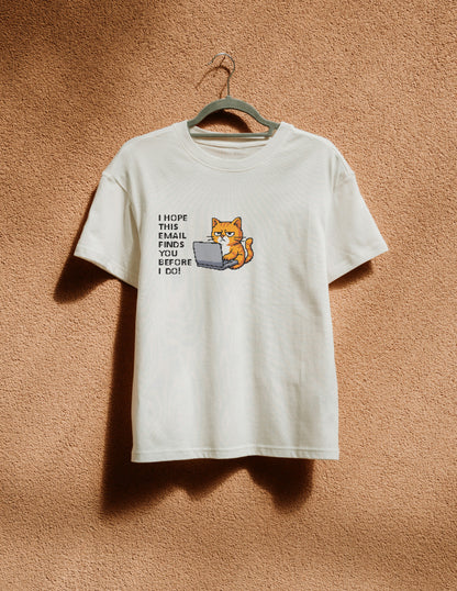 White t-shirt with a graphic of a cat using a laptop and text on a beige background