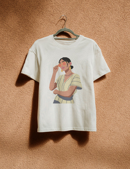 White t-shirt with a graphic of a woman on a beige wall