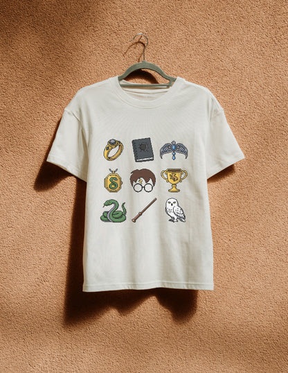 White t-shirt with Harry Potter-themed graphics on a beige wall