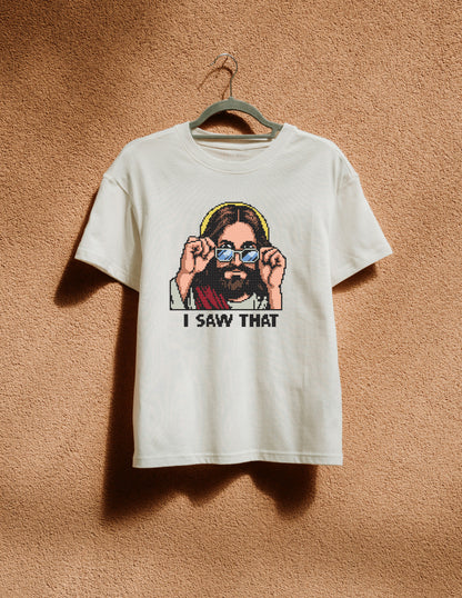 White t-shirt with graphic design of a person wearing sunglasses and text 'I SAW THAT' on a beige background.
