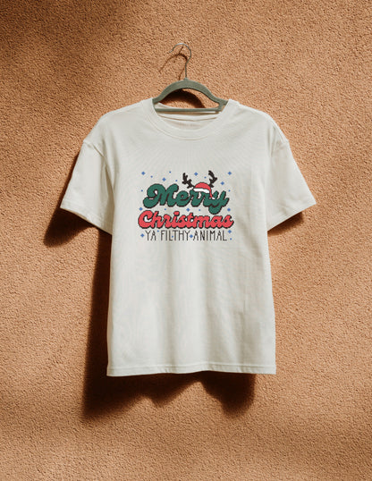 White t-shirt with Christmas design on a hanger against a brown textured wall