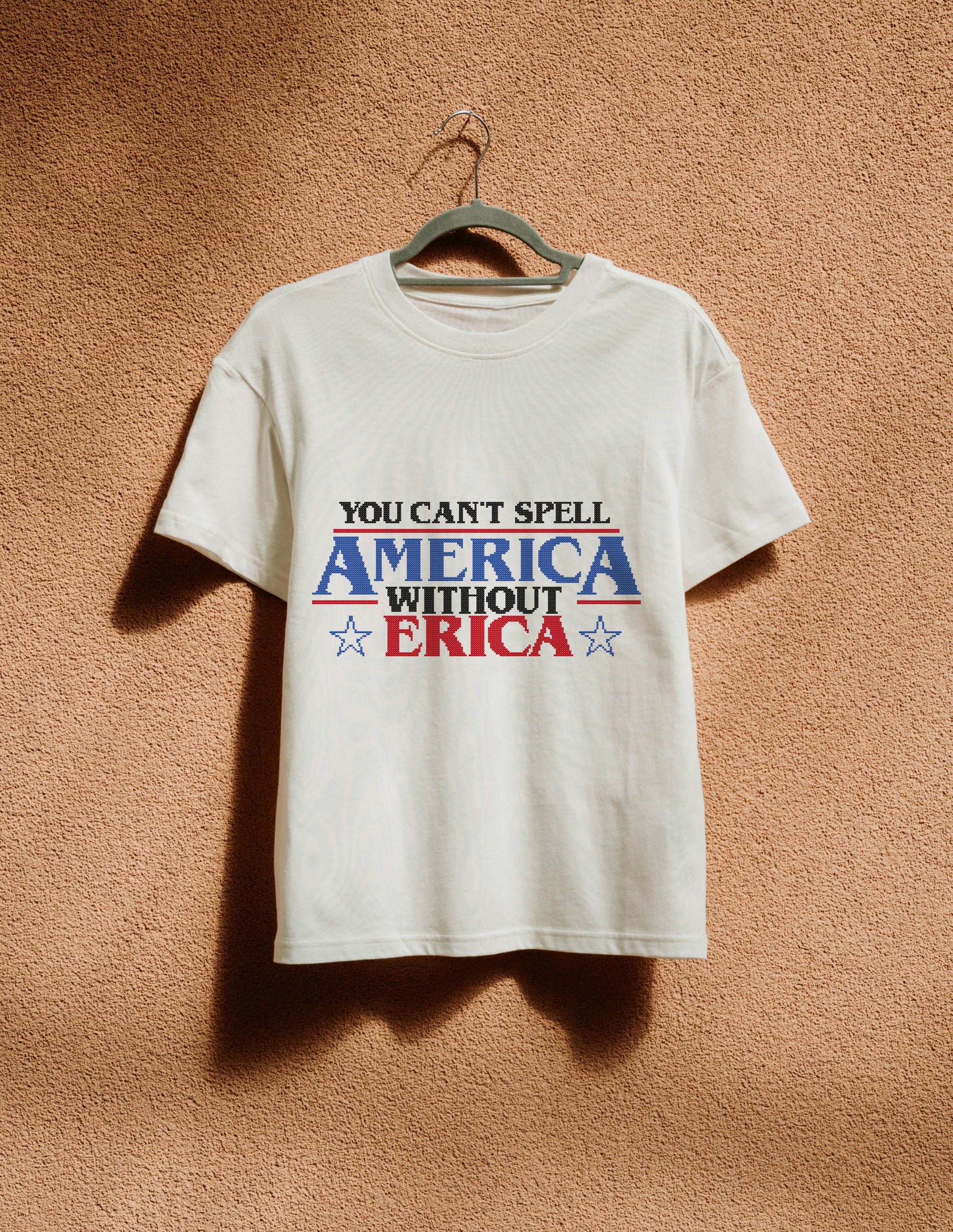 White t-shirt with 'You can't spell America without Erica' text on a beige background