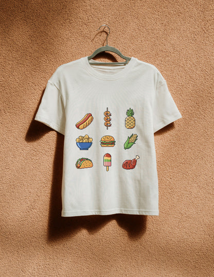 White t-shirt with food illustrations on a hanger against a brown textured wall